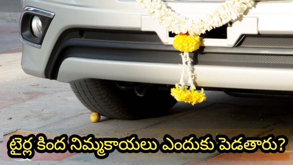 Car crushing lemons under its front tires as part of a traditional Indian ritual for protection.